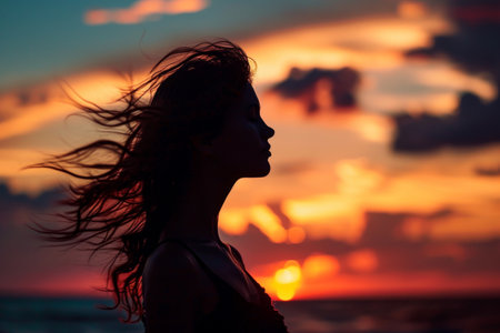 Young woman s silhouette against a sunset, Woman s figure on sky at sunset with empty space AI generatedの素材