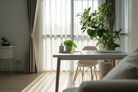 Minimalist home office you'll find a white desk a green plant and abundant natural light AI generatedの素材