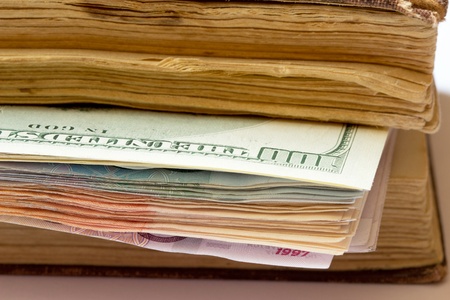 dollars as a bookmark in an old bookの写真素材