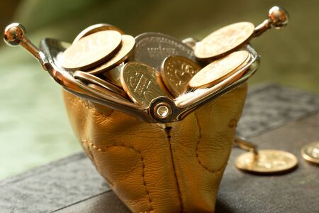   metal coins and small yellow purseの写真素材