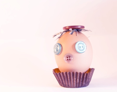 Easter egg with eyes and mouth of the buttons