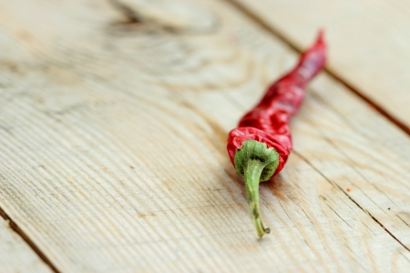 One pod is dry hot pepper on a wooden fenceの写真素材