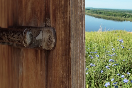 view of the river behind the open doorの写真素材