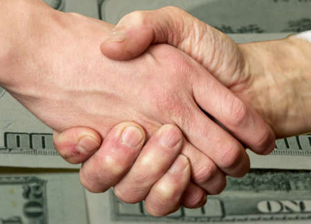 merged two male hands in a handshakeの写真素材