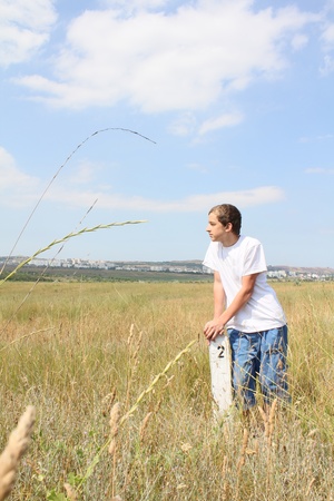 young boy on the steppe landscapeの写真素材