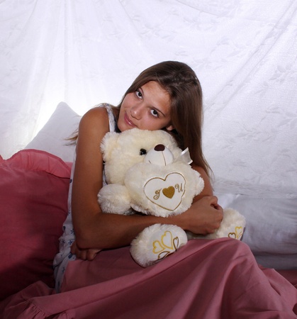 Young beautiful girl with toy bearの写真素材