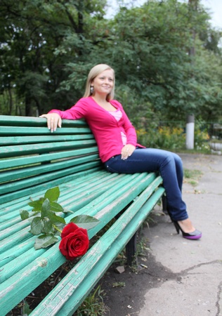 	rose on the bench and young womanの写真素材