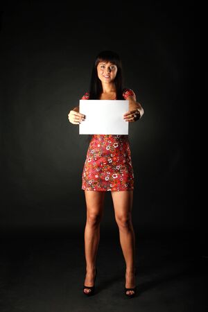 	young beautiful woman with white sheet of paperの写真素材