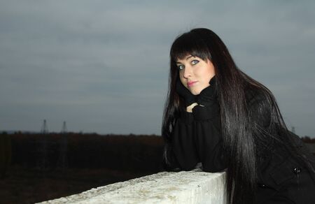	Young attractive woman on the roofの写真素材