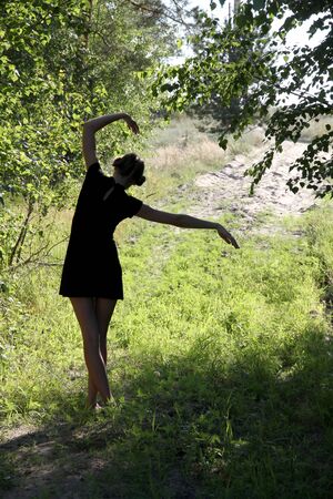 silhouette of young beautiful girl in the forestの写真素材