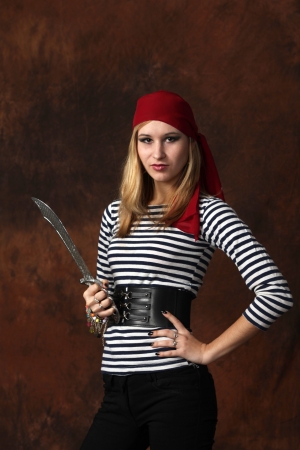 Beautiful young woman pirate posingの写真素材