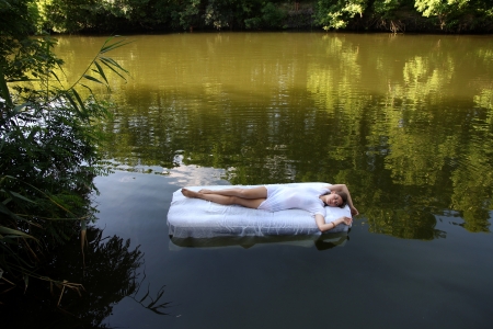 Beautiful girl lying on the mattressの写真素材