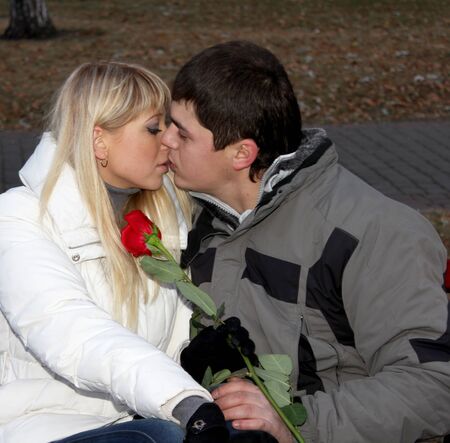 Kissing couple in love with the roseの写真素材