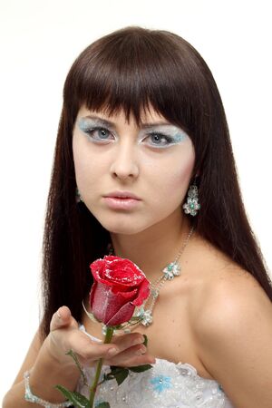 Close-up portraits girl in a snow queen with iced roseの写真素材