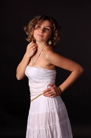 Stylish passionate young girl in a white dressの写真素材