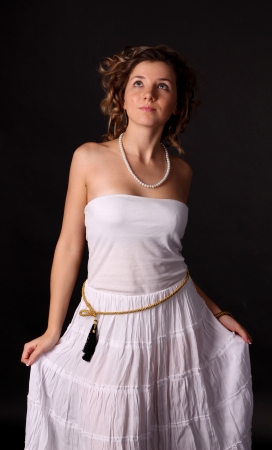 A beautiful young surprised girl in white dressの写真素材
