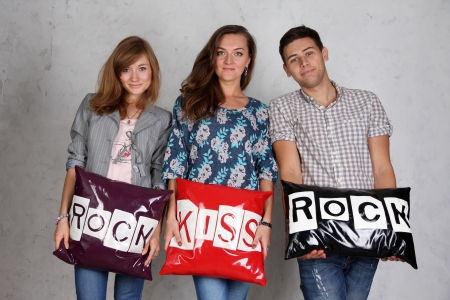 The three friends with pillows  rock  and  kiss 