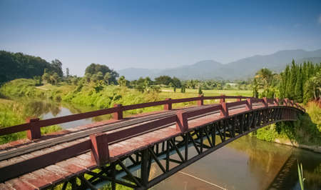 The wooden bridge has a walkway leading to the beautiful natural scenery in Thailand.の写真素材