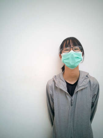 An Asian tourist girl, takes a mask every time she does in her daily life.の写真素材