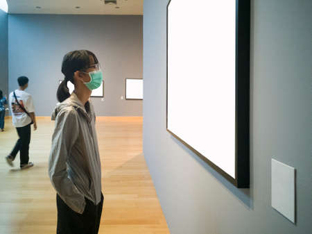 An Asian tourist girl, takes a mask every time she does in her daily life.の写真素材