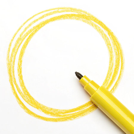 Yellow felt-tip pen drawing a circle on a white background.の写真素材