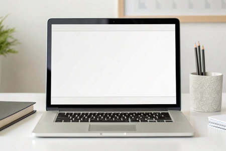 Laptop with blank screen on white desk in office. Mock up