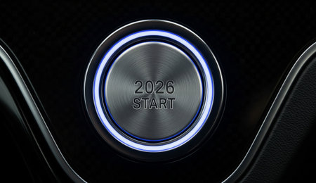 a close up of a start button with 2026 on it surrounded by blue led lighting on a sleek black...