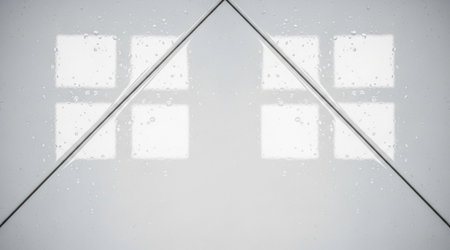 Glossy white surface with water drops reflects illumination creating geometric symmetry wet smooth background textureの写真素材