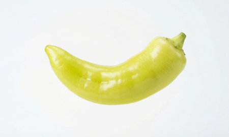 Fresh long yellow pepper with green stem on white surface, healthy food ingredient