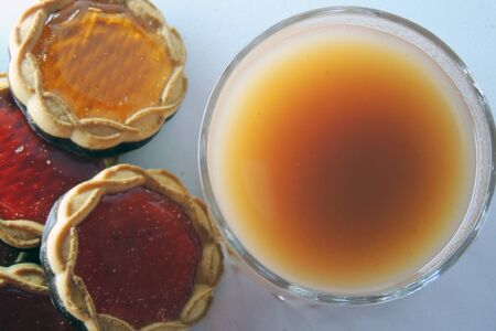 Orange juice and cookies on tablecloth .の写真素材