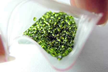 Green beads on white background .