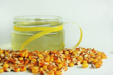 Corn oil in a jar, corn on white backgroundの写真素材