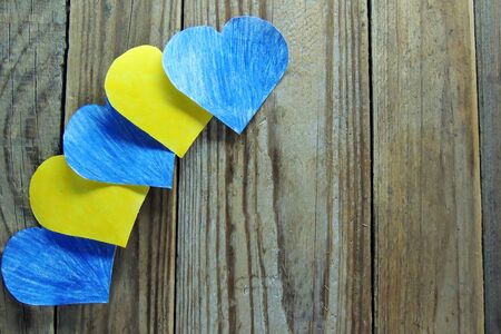 Decorative blue and yellow hearts on wooden background. Image of Valentines dayの写真素材