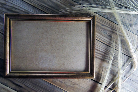 Old photo frames on wood background with wheat