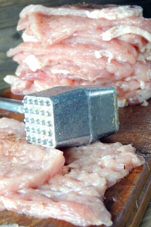 The Piece of crude meat lie on wooden chopping boardの写真素材