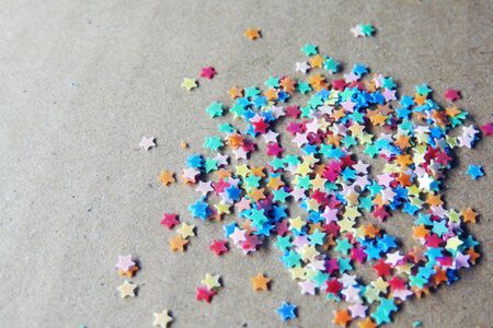 Stars of different colors, blue, red, green, yellow, on a brown backgroundの写真素材