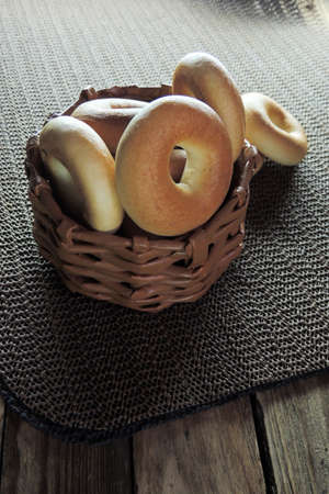Variety of fresh bagels on rustic wooden background