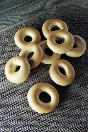 Variety of fresh bagels on rustic wooden background