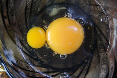 Chicken and quail eggs, wheat on wooden tableの写真素材