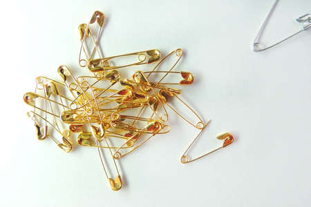 Isolated, open safety pin in white backgroundの写真素材