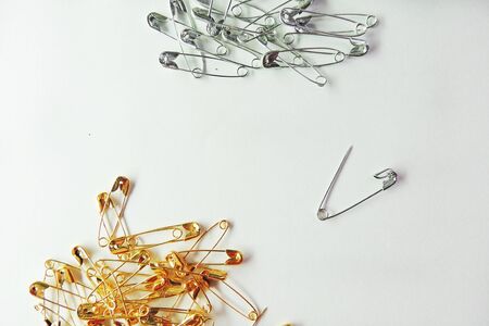Isolated, open safety pin in white background