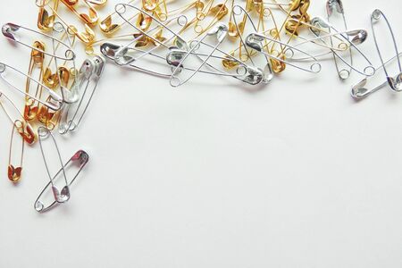 Isolated, open safety pin in white backgroundの写真素材