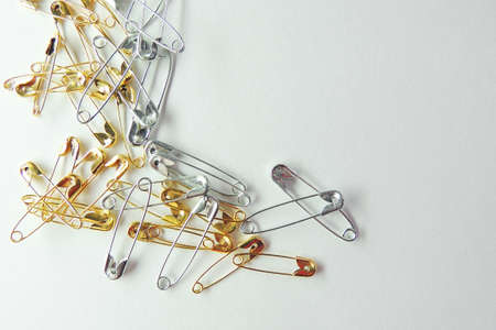 Isolated, open safety pin in white backgroundの写真素材