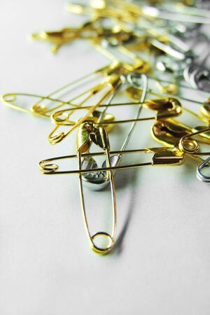 Isolated, open safety pin in white background