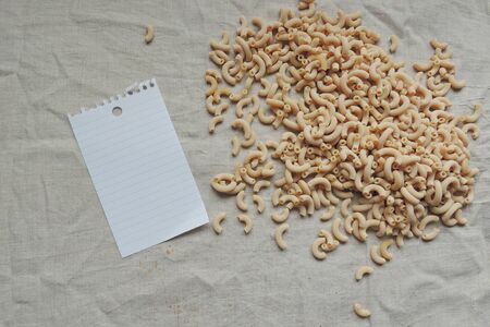 Pasta, spatula and pad on a wooden table
