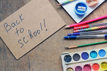 School supplies on blackboard background ready for your design