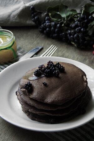 Chocolate pancake with chocolate glaze,raspberries and mint.selective focus
