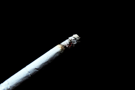 Real smoke from burning cigarette, black backgroundの写真素材
