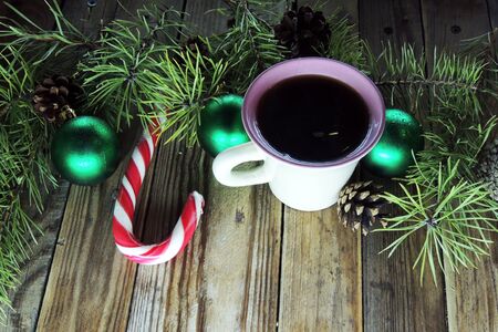 Hot Coffee cup on a frosty winter day window background with candy canes Christmas holidays background Winter cozy backgroundの写真素材