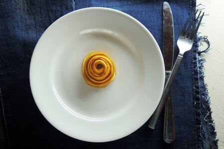 White empty plate and fork and knife on wooden texture backgroundの写真素材
